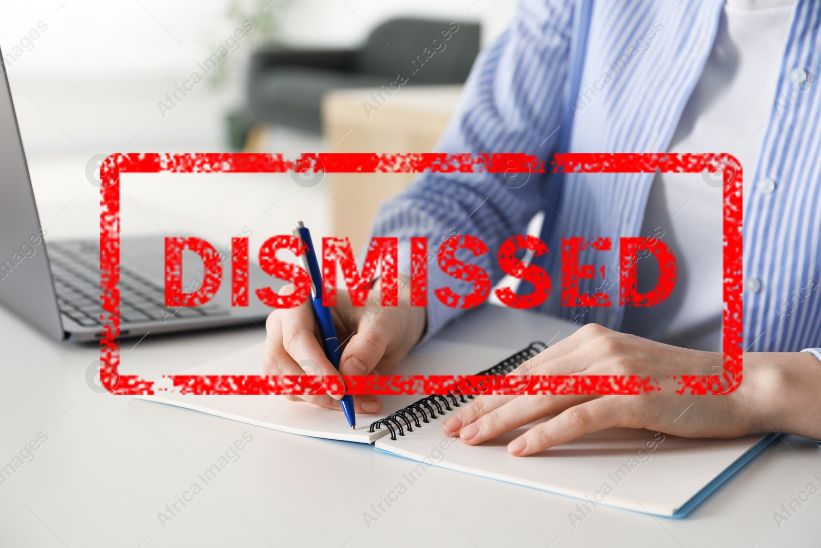 Woman working at table and red stamp Dismissed, closeup Image of Woman working at table and red stamp Dismissed, closeup