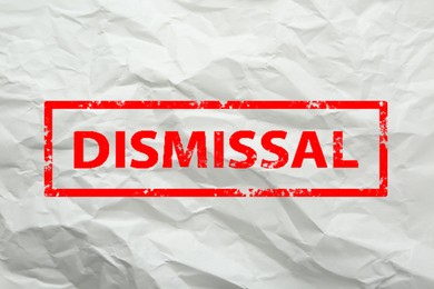 Image of Red stamp Dismissal on crumpled paper sheet