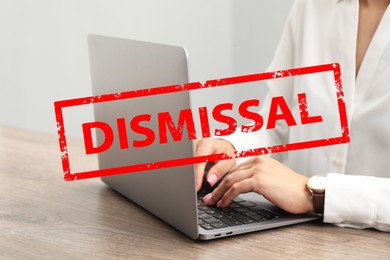 Image of Woman using laptop at table and red stamp Dismissal, closeup
