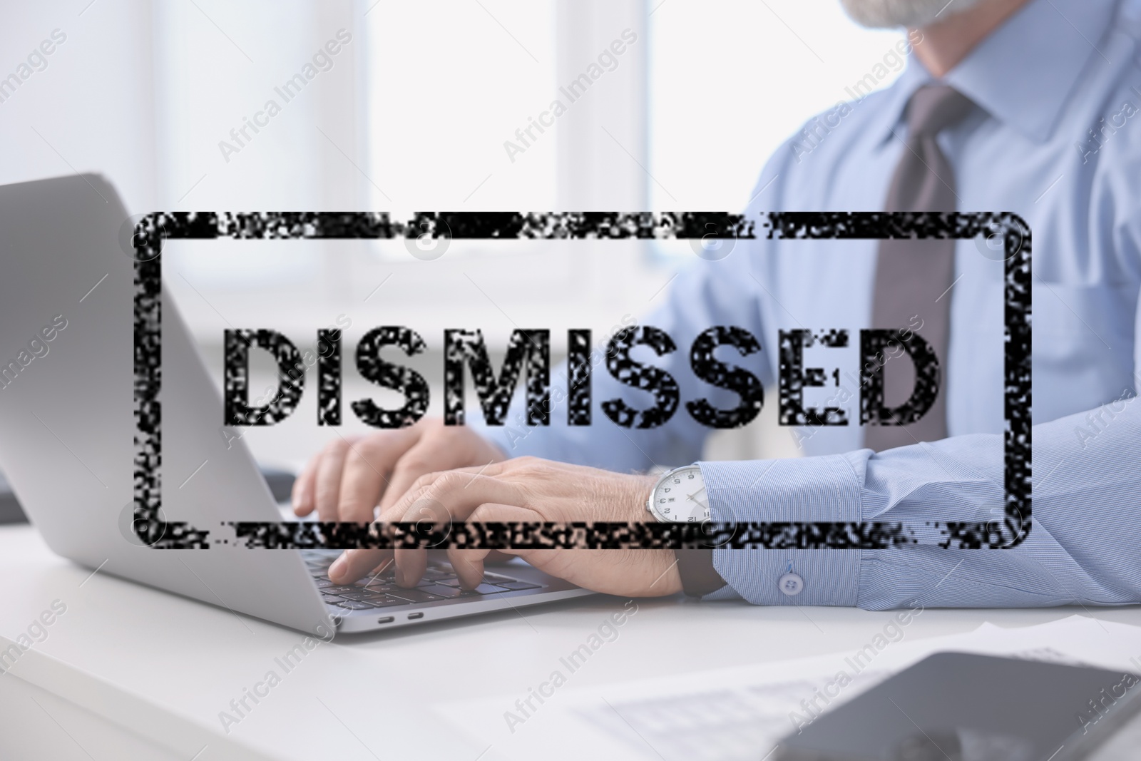Image of Man using laptop at table and black stamp Dismissed, closeup