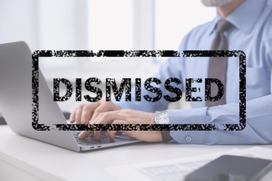 Image of Man using laptop at table and black stamp Dismissed, closeup