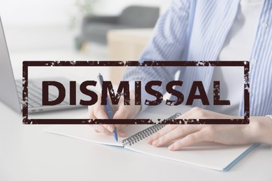Image of Woman using laptop at table and stamp Dismissal, closeup