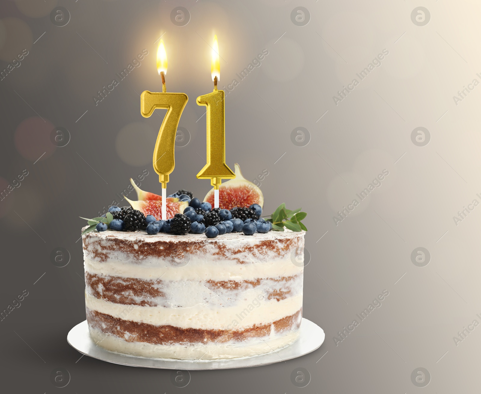Yummy cake with burning number shaped candles on grey gradient background, space for text. 71th birthday or other special occasion Image of Yummy cake with burning number shaped candles on grey gradient background, space for text. 71th birthday or other special occasion
