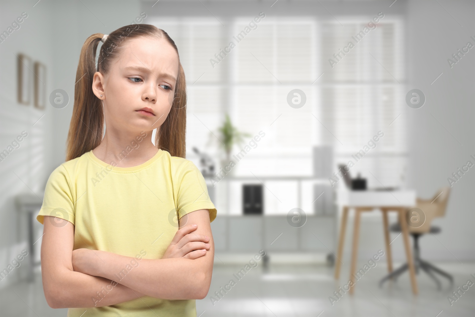 Image of Sad little girl in children's hospital. Space for text