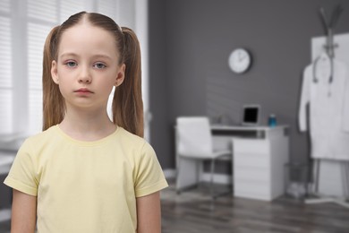 Image of Sad little girl in children's hospital. Space for text