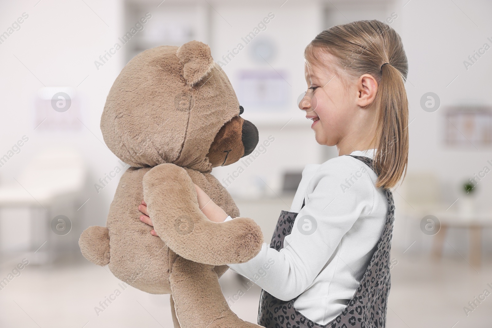 Cute little girl with toy bear in children's hospital Image of Cute little girl with toy bear in children's hospital