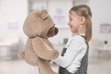 Image of Cute little girl with toy bear in children's hospital