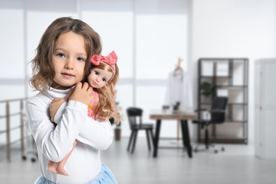 Image of Cute little girl with doll in pediatrician's office. Children's hospital