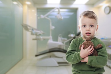 Image of Cute little boy with toy bear in children's hospital