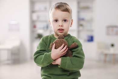 Image of Cute little boy with toy bear in pediatrician's office. Children's hospital