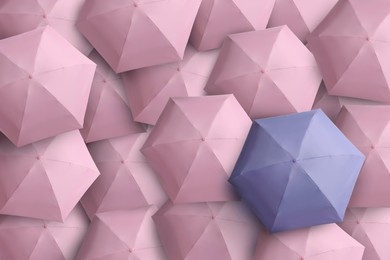 Image of Lavender umbrella among pink ones, top view