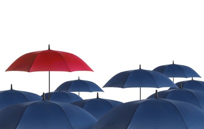 Image of Red umbrella among blue ones against white background