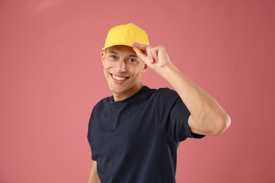 Photo of Young man in stylish baseball hat on pink background