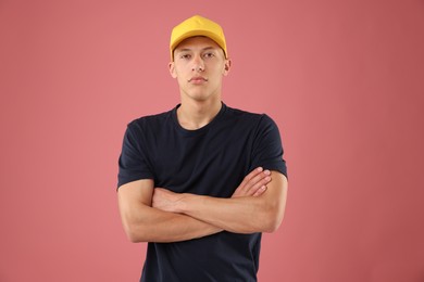 Photo of Young man in stylish baseball hat on pink background