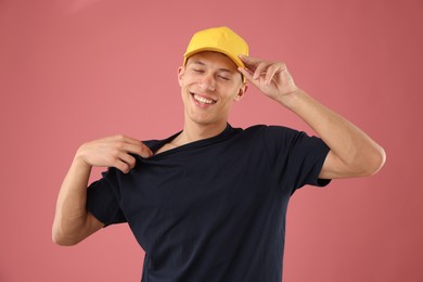 Photo of Young man in stylish baseball hat on pink background