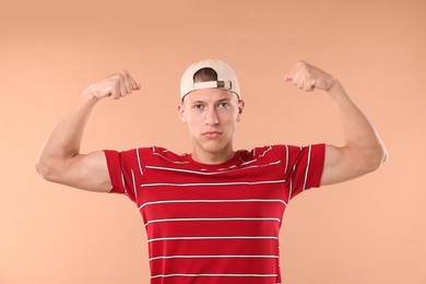 Photo of Young man in stylish baseball hat on beige background