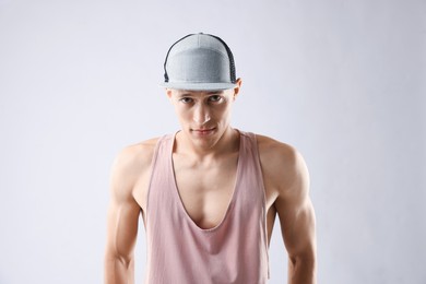 Photo of Young man in stylish baseball hat on light grey background
