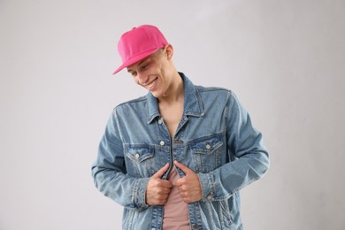 Photo of Young man in stylish baseball hat on light grey background