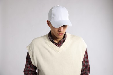 Photo of Young man in stylish baseball hat on light grey background