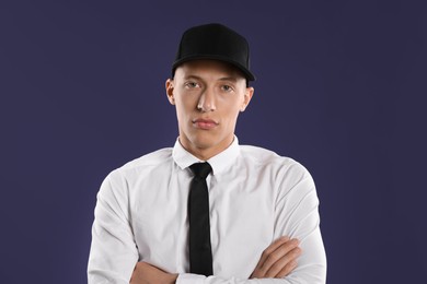 Photo of Young man in stylish baseball hat on dark blue background