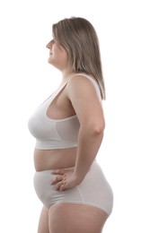 Photo of Weight loss. Plus size woman in underwear on white background