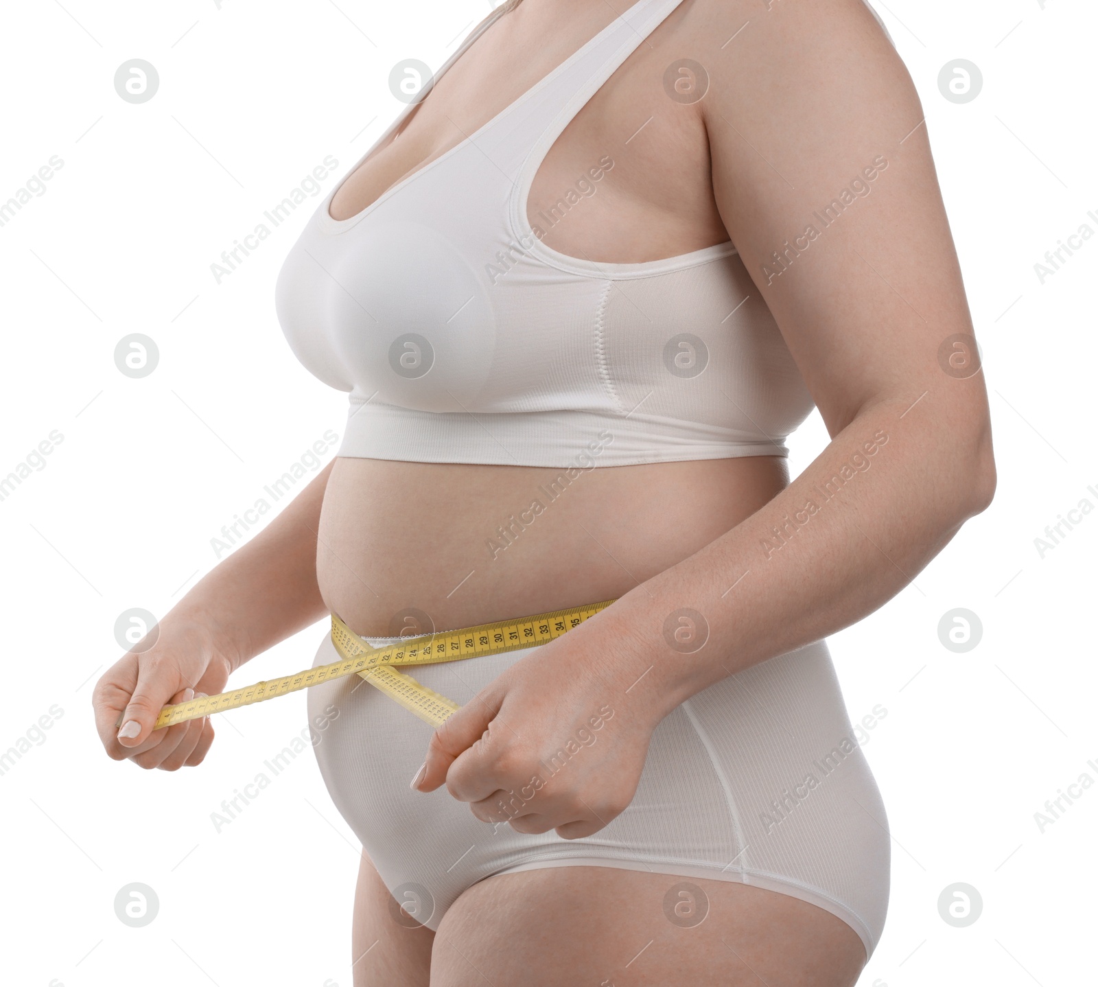 Weight loss. Plus size woman measuring waist with tape on white background, closeup Photo of Weight loss. Plus size woman measuring waist with tape on white background, closeup