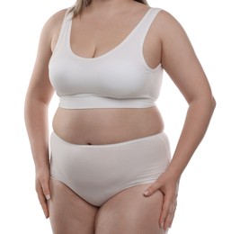 Photo of Weight loss. Plus size woman in underwear on white background, closeup