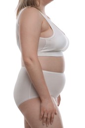 Photo of Weight loss. Plus size woman in underwear on white background, closeup