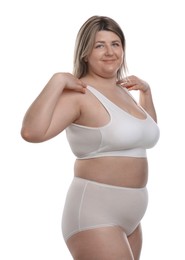 Photo of Weight loss. Plus size woman in underwear on white background