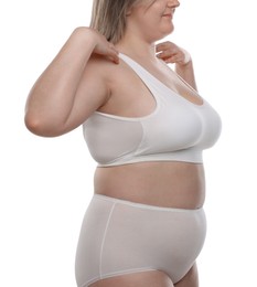 Photo of Weight loss. Plus size woman in underwear on white background, closeup