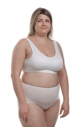 Photo of Weight loss. Plus size woman in underwear on white background