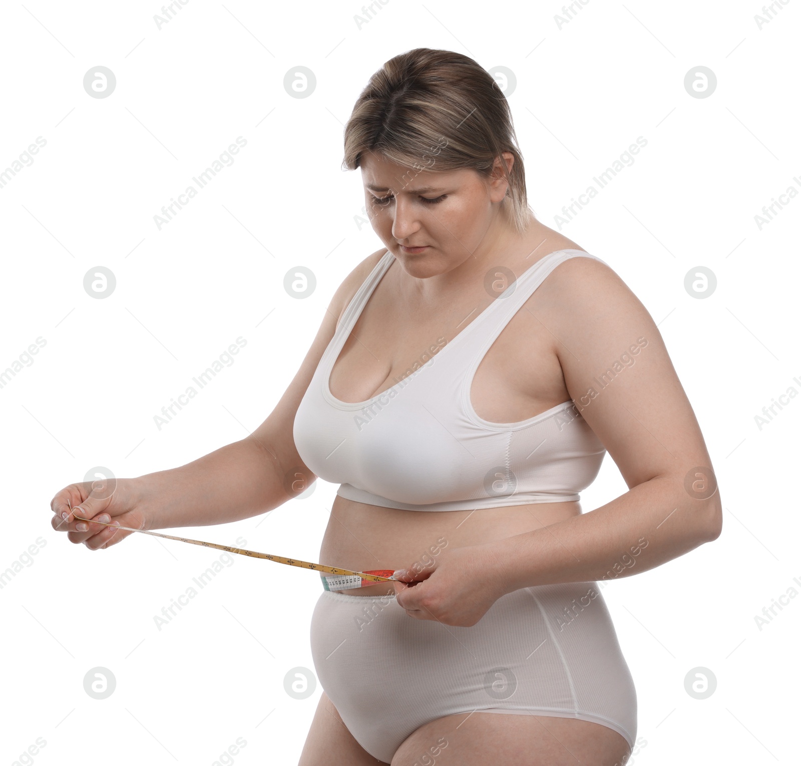 Weight loss. Plus size woman measuring waist with tape on white background Photo of Weight loss. Plus size woman measuring waist with tape on white background