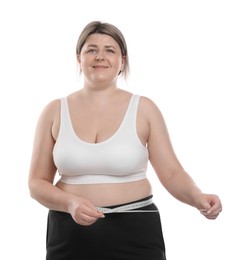 Photo of Weight loss. Plus size woman measuring waist with tape on white background