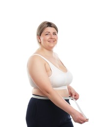 Photo of Weight loss. Plus size woman measuring waist with tape on white background