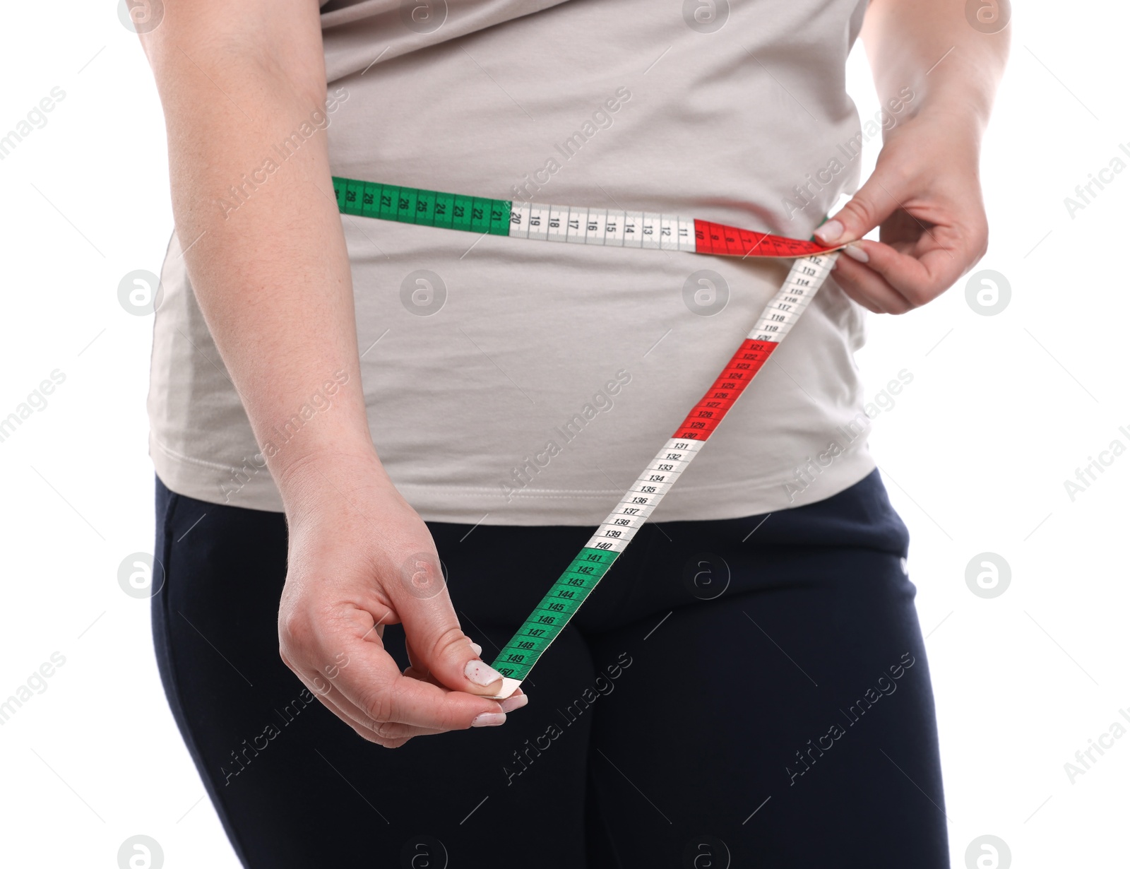 Weight loss. Plus size woman measuring waist with tape on white background, closeup Photo of Weight loss. Plus size woman measuring waist with tape on white background, closeup