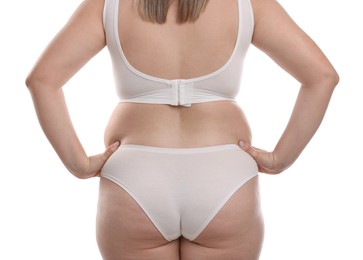 Photo of Weight loss. Plus size woman in underwear on white background, closeup