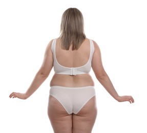 Photo of Weight loss. Plus size woman in underwear on white background, back view