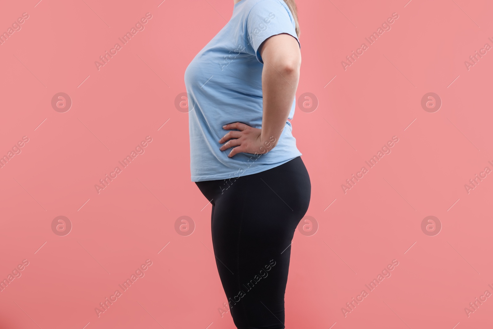 Weight loss. Plus size woman on pink background, closeup Photo of Weight loss. Plus size woman on pink background, closeup
