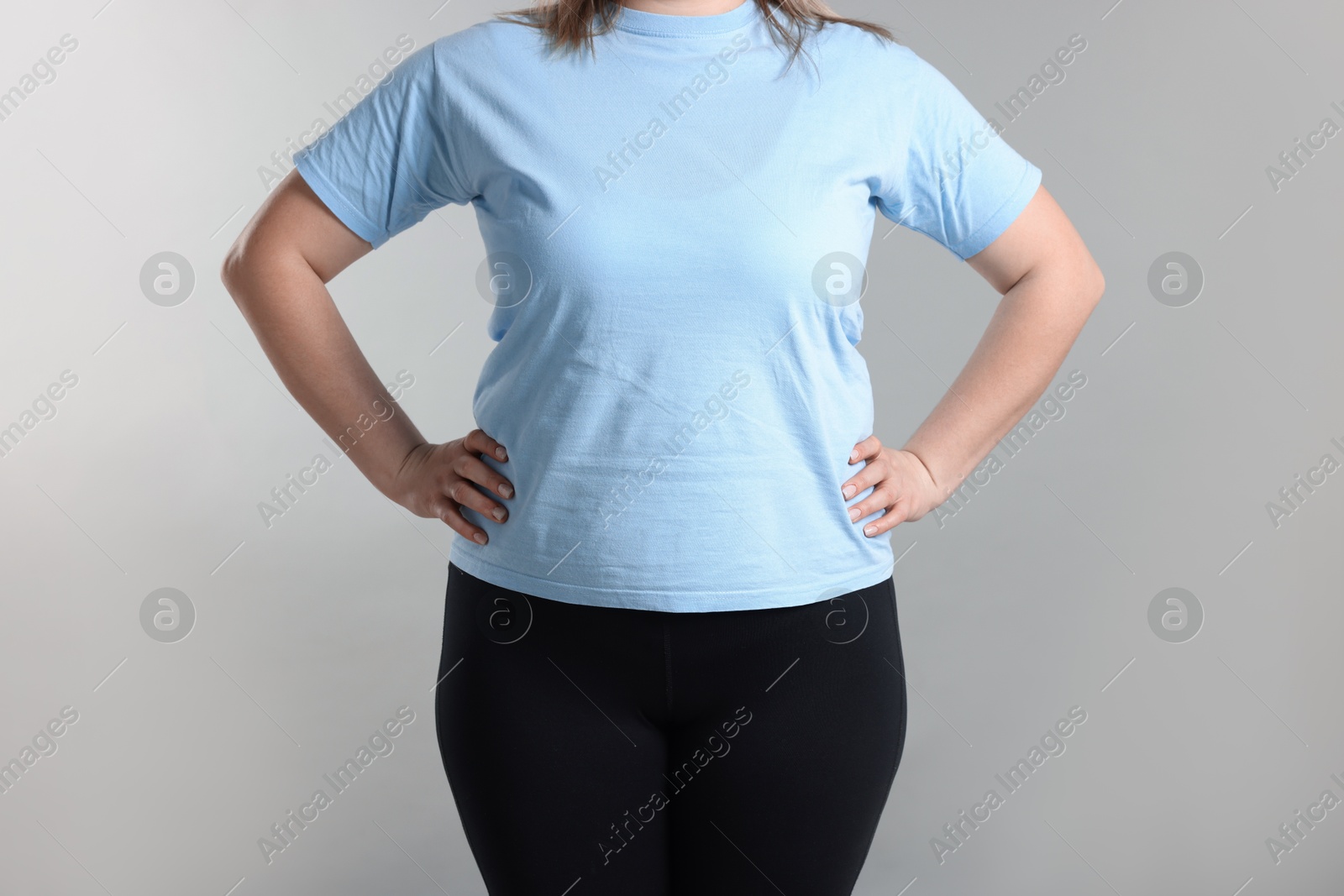 Weight loss. Plus size woman on gray background, closeup Photo of Weight loss. Plus size woman on gray background, closeup