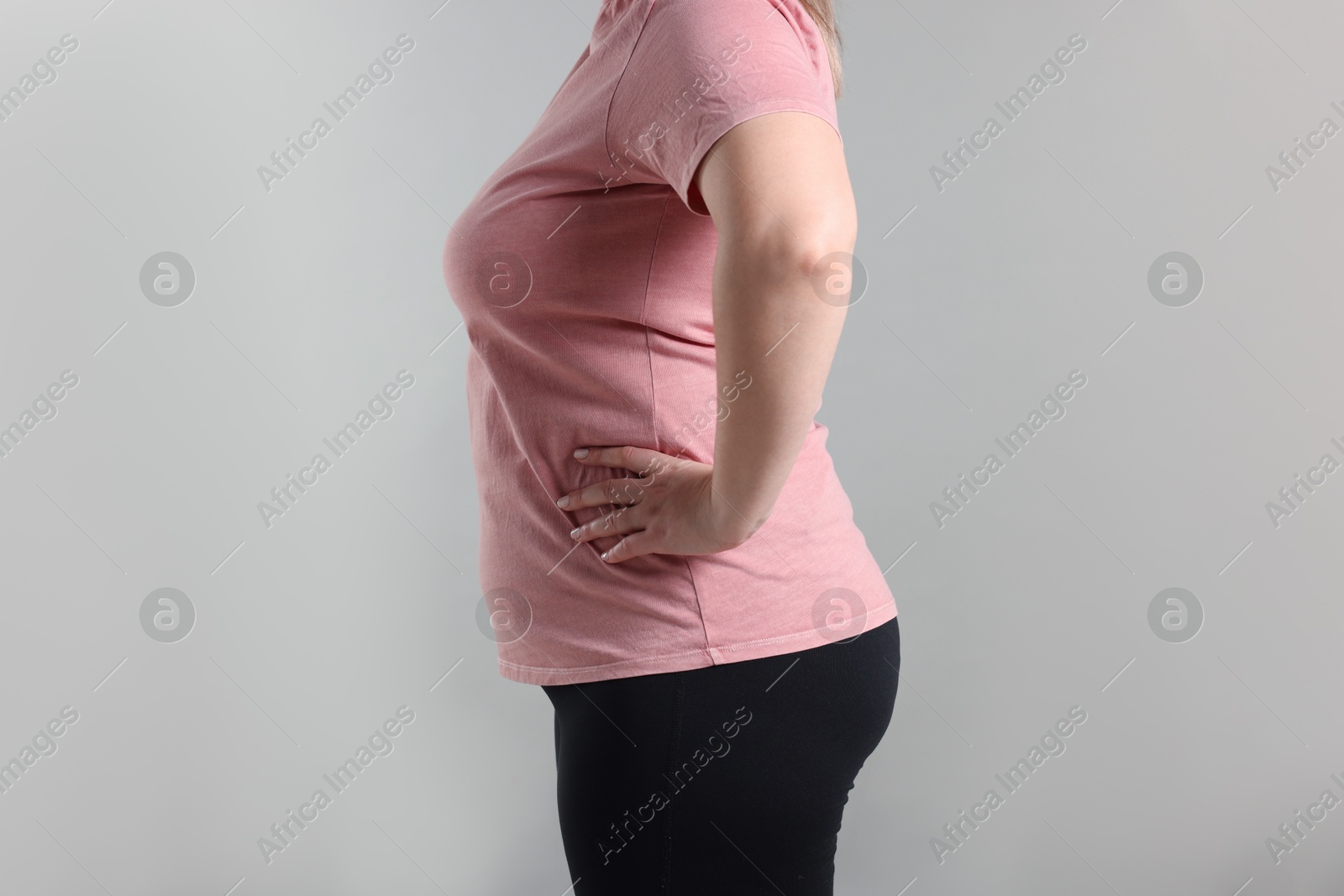 Weight loss. Plus size woman on gray background, closeup Photo of Weight loss. Plus size woman on gray background, closeup
