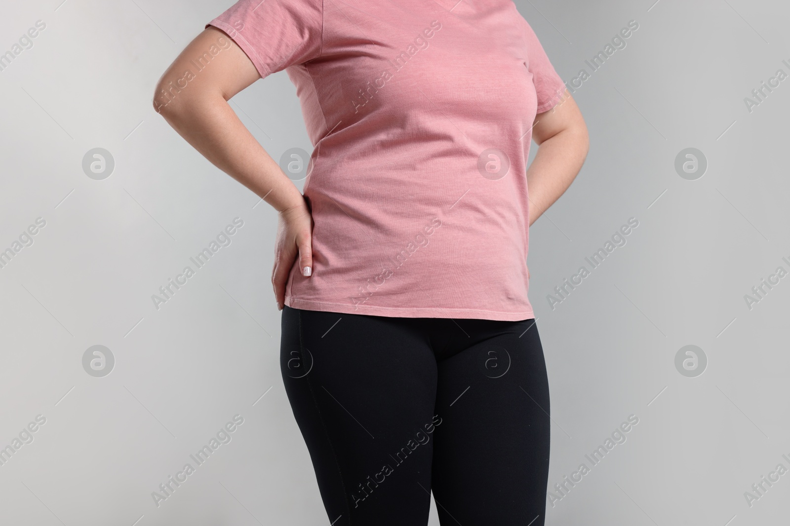 Weight loss. Plus size woman on gray background, closeup Photo of Weight loss. Plus size woman on gray background, closeup