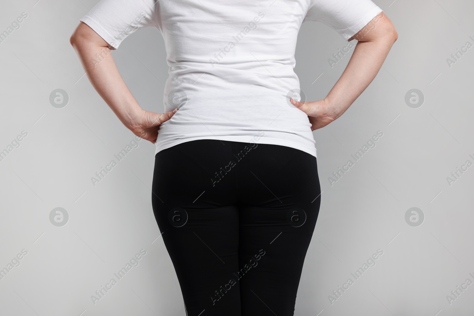 Weight loss. Plus size woman on gray background, closeup Photo of Weight loss. Plus size woman on gray background, closeup