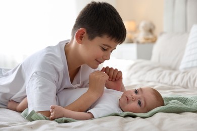 Photo of Cute little brothers on bed at home