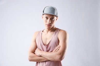 Photo of Young man in stylish baseball hat on light grey background
