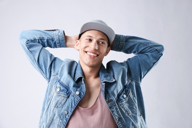 Photo of Young man in stylish baseball hat on light grey background