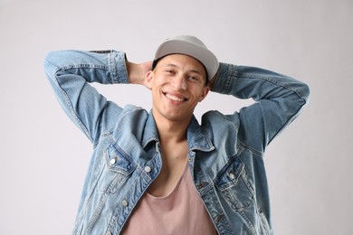 Photo of Young man in stylish baseball hat on light grey background