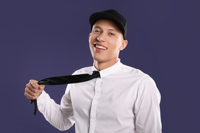 Photo of Young man in stylish baseball hat on dark blue background