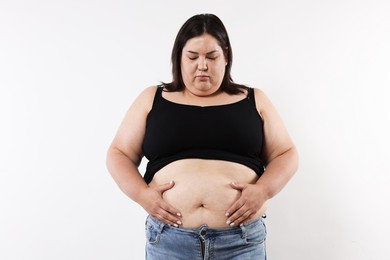 Photo of Woman with excessive belly fat on white background