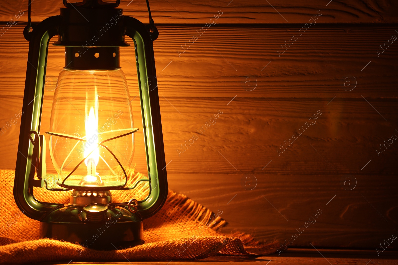 Vintage kerosene lamp on wooden table, closeup. Space for text Photo of Vintage kerosene lamp on wooden table, closeup. Space for text