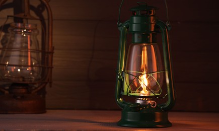 Photo of Vintage kerosene metal lamps on wooden table